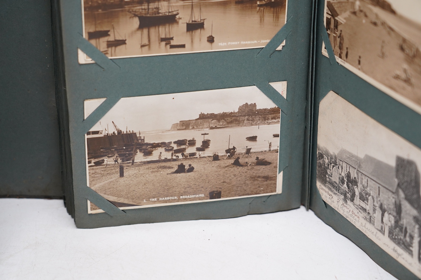 An Edwardian ‘The Cabinet’ postcard album, containing Edwardian and later postcards, mostly topographical. Condition - fair